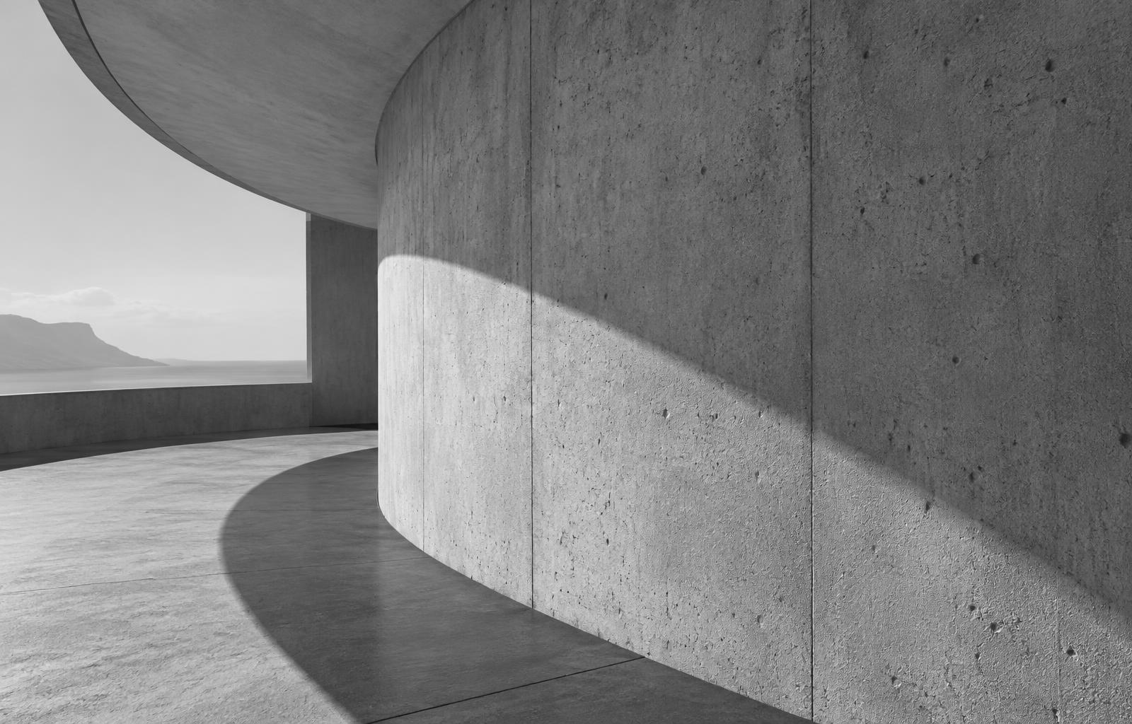 Light and shadow moving across a curved concrete facade